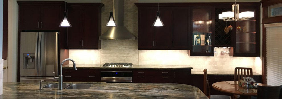 Open Concept Kitchen With Dark Cabinets And Quartzite Countertops