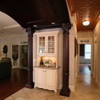 Another shot of two of the four solid cherry columns flanking custom furniture pieces by Wood-Mode.