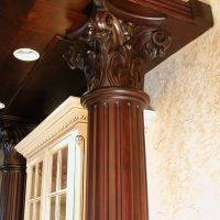 Close-up of the solid cherry carved capitals atop the solid cherry columns, and a better view of the crown molding with egg & dart details, also by Wood-Mode.
