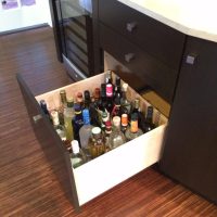 Liquor bottles are conveniently stored in this extra-deep custom divided drawer. ALL our drawers are full-extension. Custom Kitchen Design