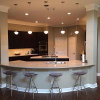 This kitchen is open to the Family Room, with seating for four or more at the curved eating counter.