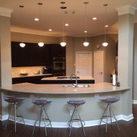 This kitchen is open to the Family Room, with seating for four or more at the curved eating counter.