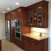 Cherry custom cabinetry by Wood-Mode (tm) with granite countertops anchor this highly functional and efficient kitchen. This gorgeous kitchen is illuminated by beautiful high-end pendant lights, along with high-efficiency LED under-cabinet lights and recessed cans.