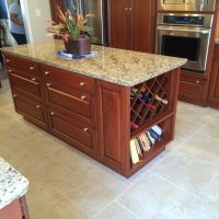 Cherry custom cabinetry by Wood-Mode (tm) with granite countertops anchor this highly functional and efficient kitchen. This gorgeous kitchen is illuminated by beautiful high-end pendant lights, along with high-efficiency LED under-cabinet lights and recessed cans.