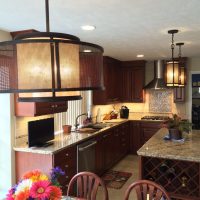 Cherry custom cabinetry by Wood-Mode (tm) with granite countertops anchor this highly functional and efficient kitchen. This gorgeous kitchen is illuminated by beautiful high-end pendant lights, along with high-efficiency LED under-cabinet lights and recessed cans.
