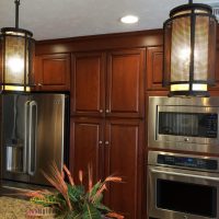 Cherry custom cabinetry by Wood-Mode (tm) with granite countertops anchor this highly functional and efficient kitchen. This gorgeous kitchen is illuminated by beautiful high-end pendant lights, along with high-efficiency LED under-cabinet lights and recessed cans.