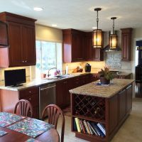 Cherry custom cabinetry by Wood-Mode (tm) with granite countertops anchor this highly functional and efficient kitchen. This gorgeous kitchen is illuminated by beautiful high-end pendant lights, along with high-efficiency LED under-cabinet lights and recessed cans.