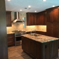 Not quite finished when these photos were taken, but it's going to be gorgeous, don't you think? Brand new custom Brookhaven cabinets, granite countertops, and all LED lighting (recessed cans and under-cabinet lights). Notice not electrical outlets in the backsplashes? They're concealed below the upper cabinets!