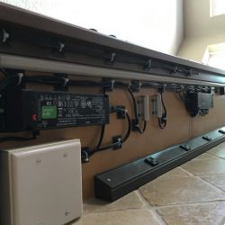 Detailed photo of intricate wiring of the cabinet interior lights, under-cabinet lights, and Angled Power Strips, all hidden under the hutch upper cabinets.