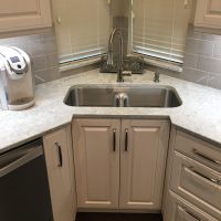This special recessed corner cabinet provides more comfortable use of the corner sink. The innovative low-divide sink provides two bowls while also offering the ability to soak large pans and even grill grates!