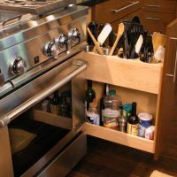 This custom pull-out unit features four stainless steel utensil baskets, slots for knives, a hole for a sharpening steel, and storage for oils and other essentials.