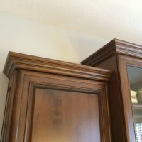 Detail shot of the crown molding and glass cabinet doors
