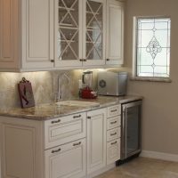 Wet bar features x-style glass doors, a deep drawer for liquor bottle storage, and a wine chiller.