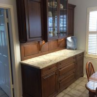 The hutch in the breakfast area provides both beauty and functionality. The wood backsplash and corbels give it more of a furniture look (custom angled power strips provide ample outlets below the upper cabinets).
