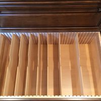 This deep custom drawer offers adjustable partitions to store lids and cookware