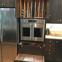 This custom tall cabinet includes vertical storage for cookie sheets & cake pans, space for a French door convection oven at the exact correct height for this chef client, and two deep drawers below.
