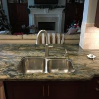 This deep under-mount stainless sink features larger and standard-sized bowls; the large one is 10