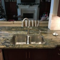 This deep under-mount stainless sink features larger and standard-sized bowls; the large one is 10