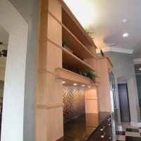 This transitional kitchen blends old with new and light with dark wood finishes, and features high-end Wood-Mode custom cabinetry with furniture detailing, and high-end stainless steel appliances.