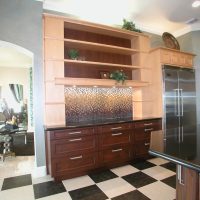 This transitional kitchen blends old with new and light with dark wood finishes, and features high-end Wood-Mode custom cabinetry with furniture detailing, and high-end stainless steel appliances.