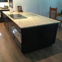 Huge peninsula provides ample work space and storage, plus a home for the induction cooktop and warming drawer