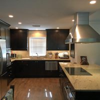 Proper lighting and light granite countertops offset the dark dramatic cabinets in this kitchen remodel in Santa Fe. Generous and highly efficient storage is provided by 27 drawers of various sizes, shapes and functions. Other unique features include organized tray storage, lid & skillet dividers, a mixer base, a LeMans corner storage unit. Brookhaven's new